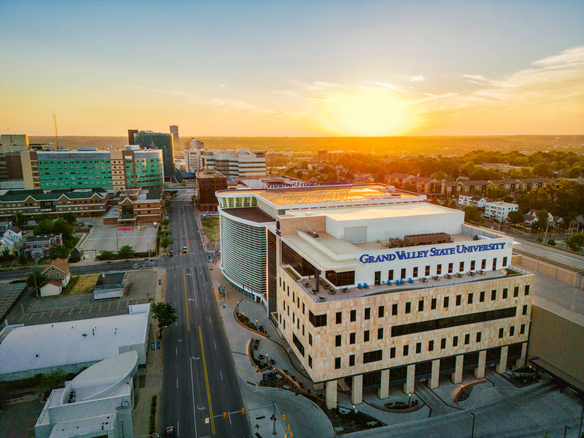 Arial of Grand Valley's Health campus with sun setting behind the buildings.